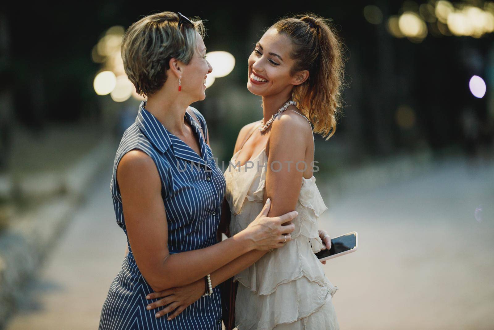 Two smiling women are having fun while enjoying a summer vacation.