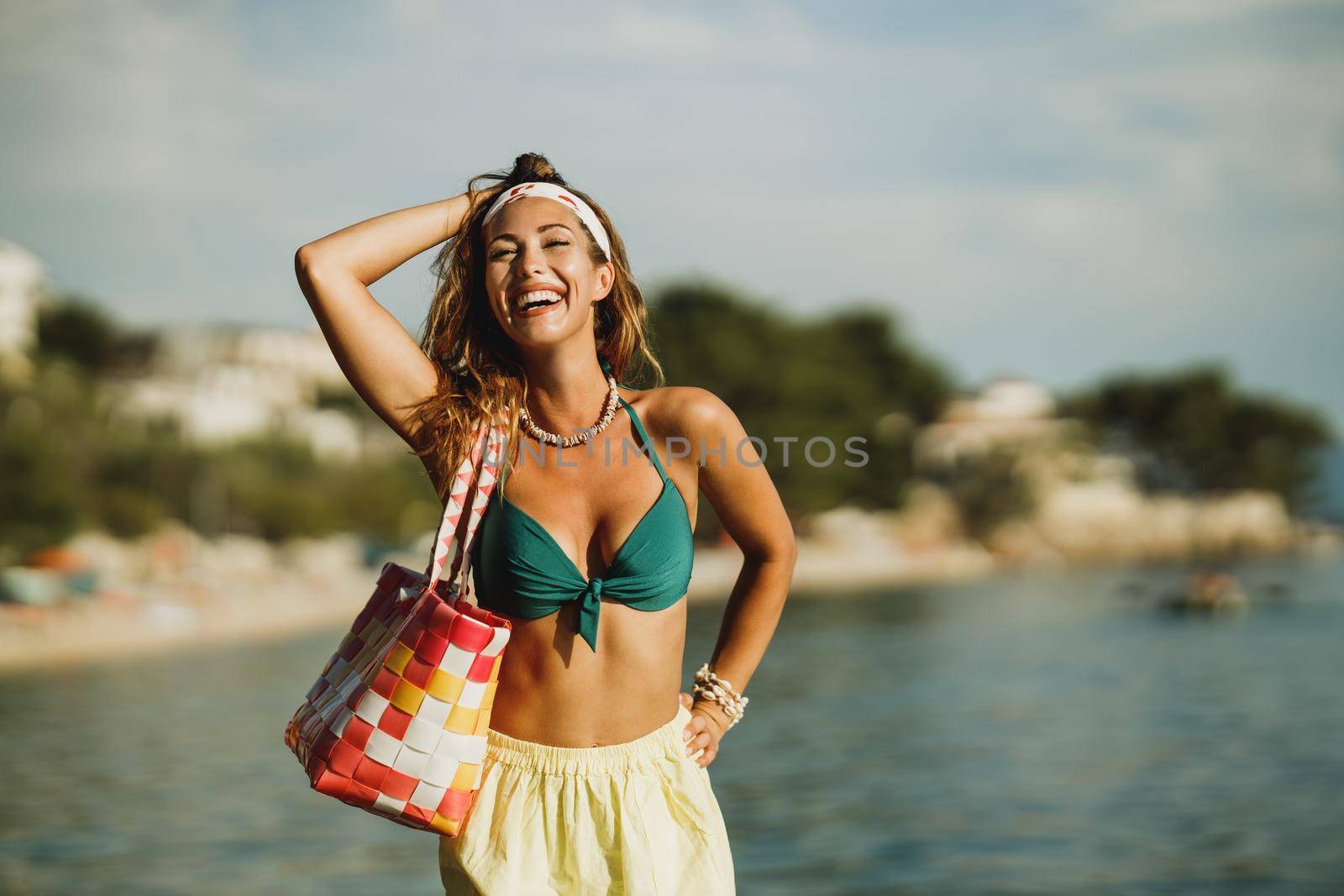 An attractive young woman in bikini is having fun on the beach and enjoying a summer vacation.