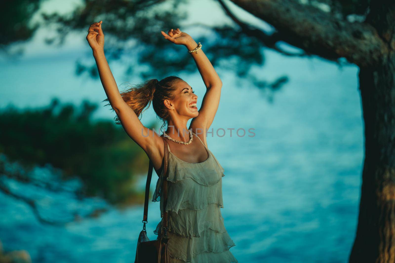 A cheerful young woman having fun on vacation and exploring Mediterranean seaside.