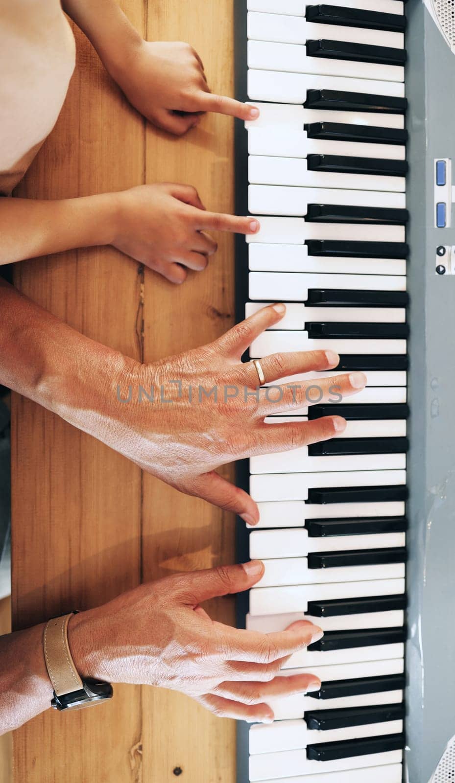 Piano, top view and hands of kid learning with father in home, playing or bonding together. Development, education or parent teaching child how to play music instrument, acoustic or electric keyboard by YuriArcurs