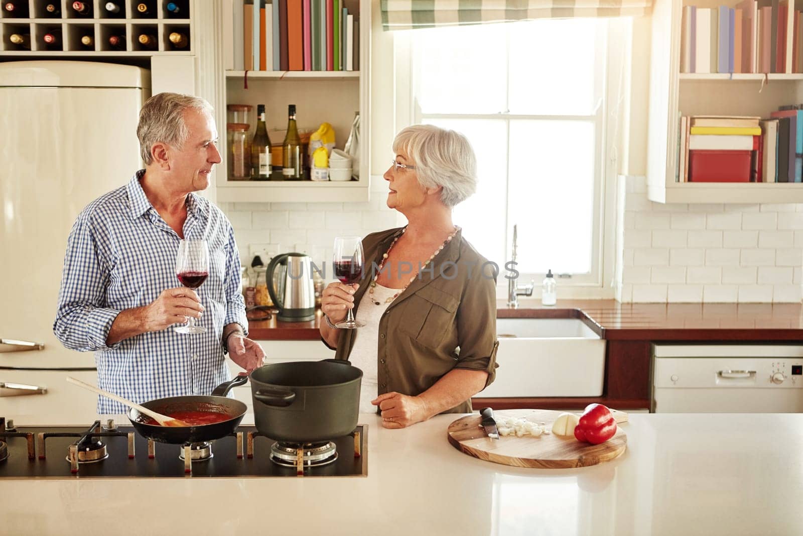 Wine, happy or old couple cooking food for a healthy vegan diet together with love in retirement at home. Smile, support or senior woman drinking or talking in house kitchen with husband at dinner.