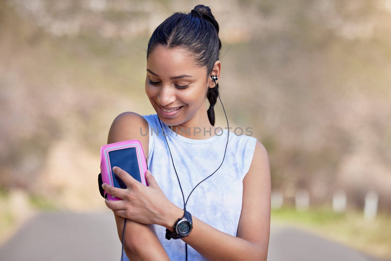 Phone, arm and woman for outdoor fitness music, wellness podcast and exercise progress, heart and cardio health. Biometric, data and mobile app of athlete, runner or sports person listening in street.