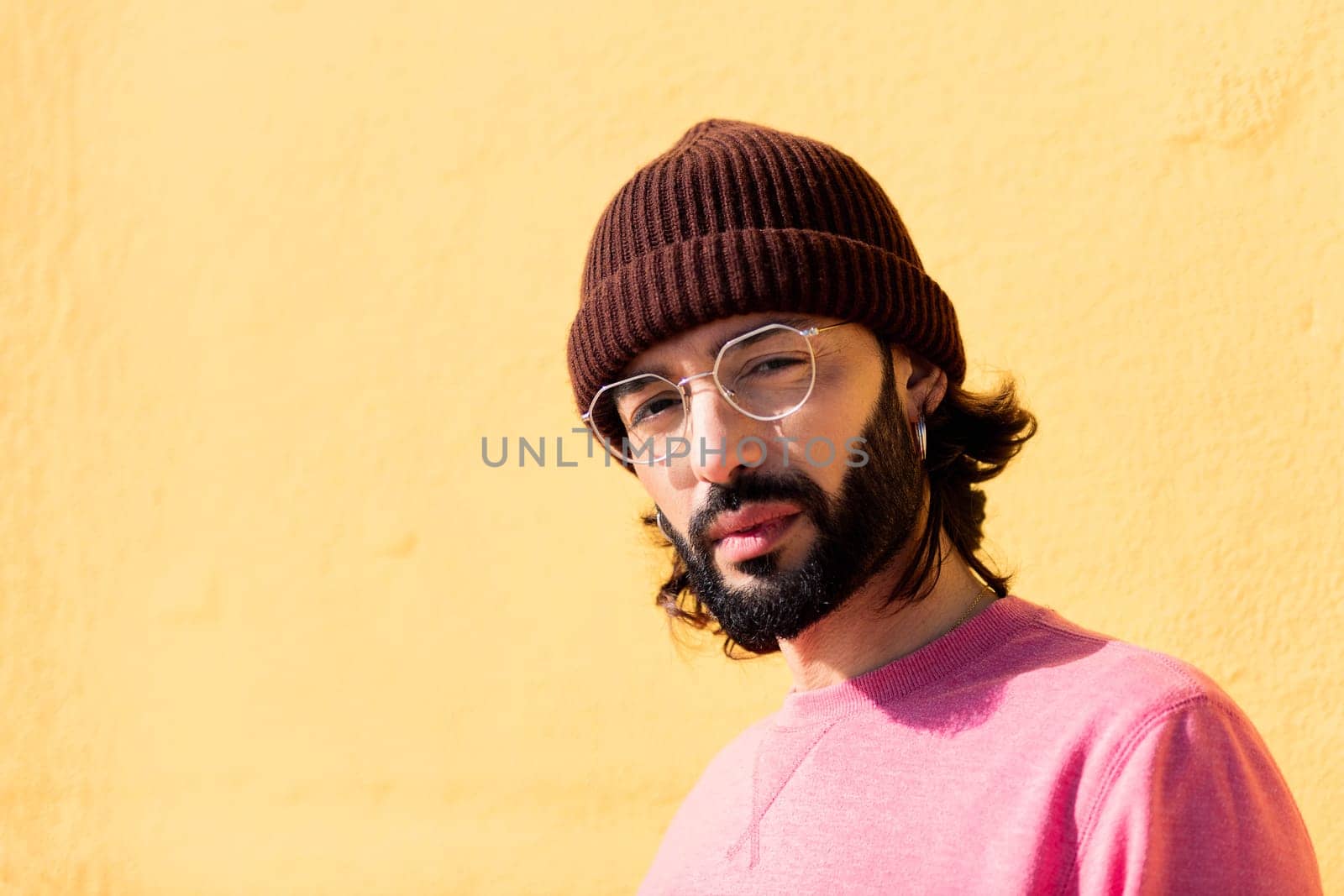 stylish young man looking serious at camera by raulmelldo