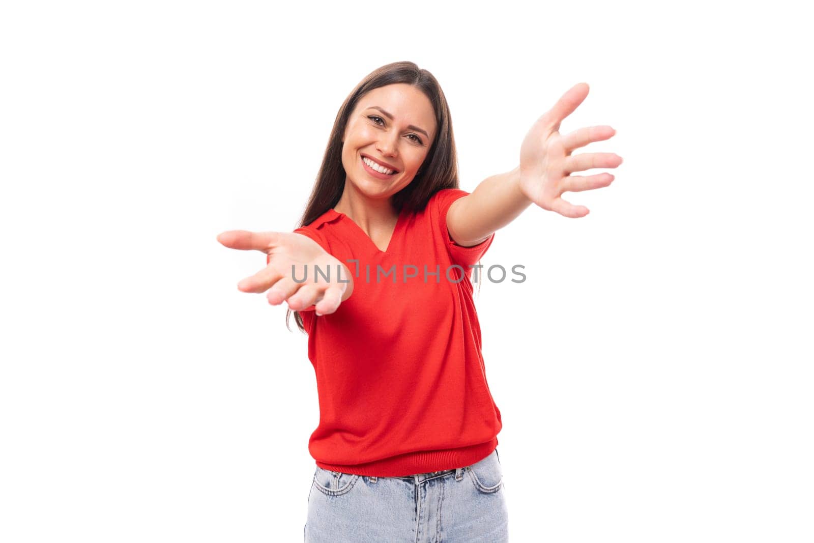 portrait of smiling pretty brunette woman with straight hair in red t-shirt and jeans isolated studio background with copy space.