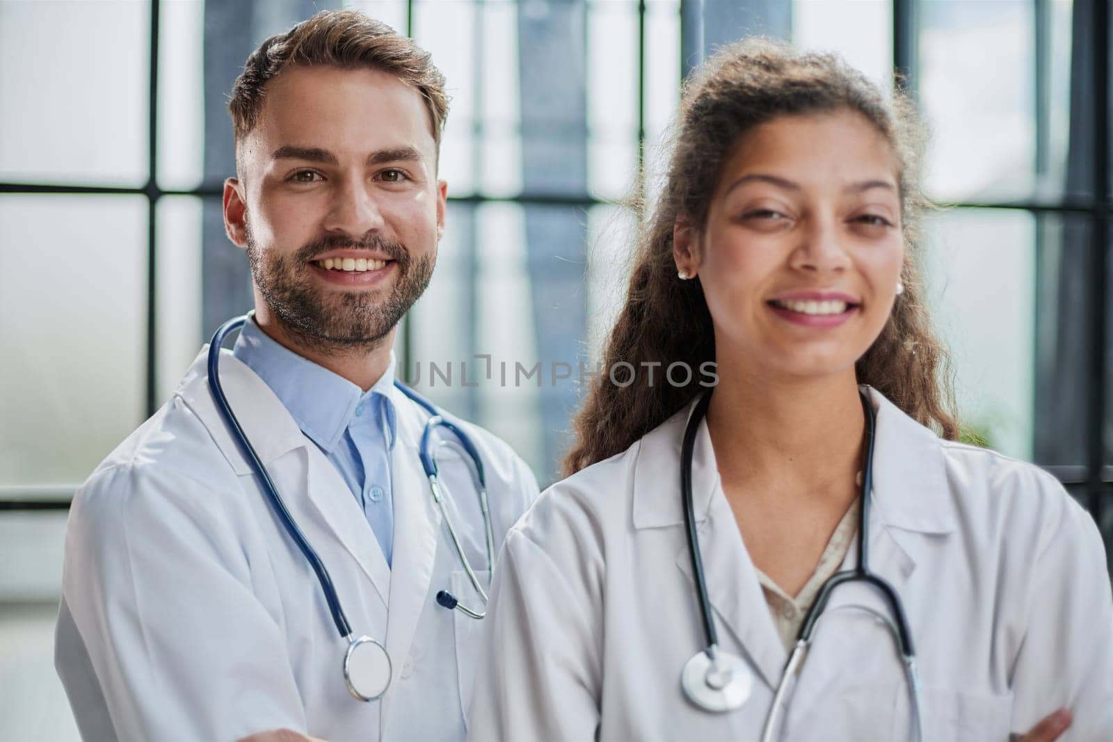 Young male and female dentists look into the distance in a hospital room