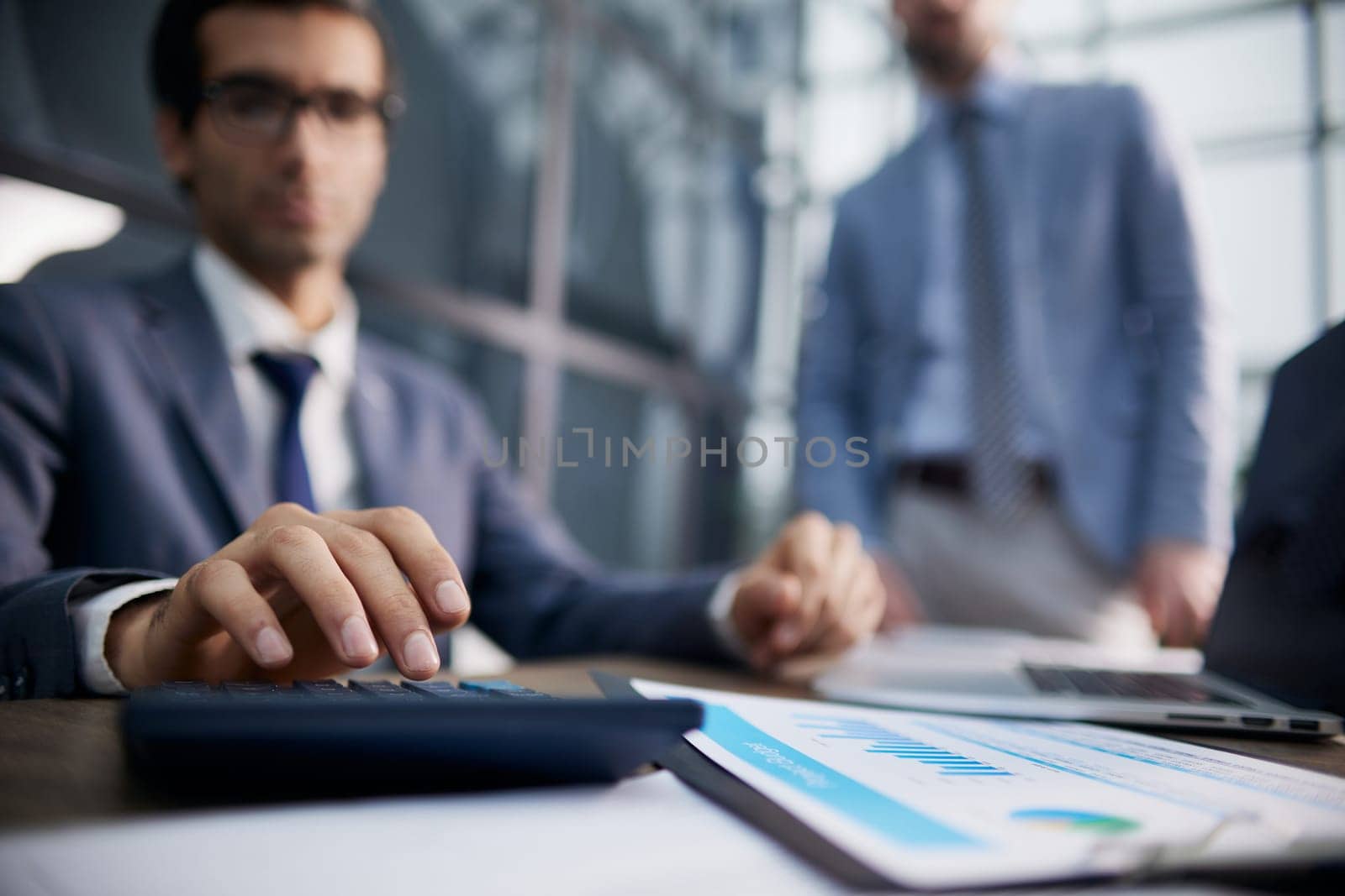 businessman uses a calculator for calculations in the office