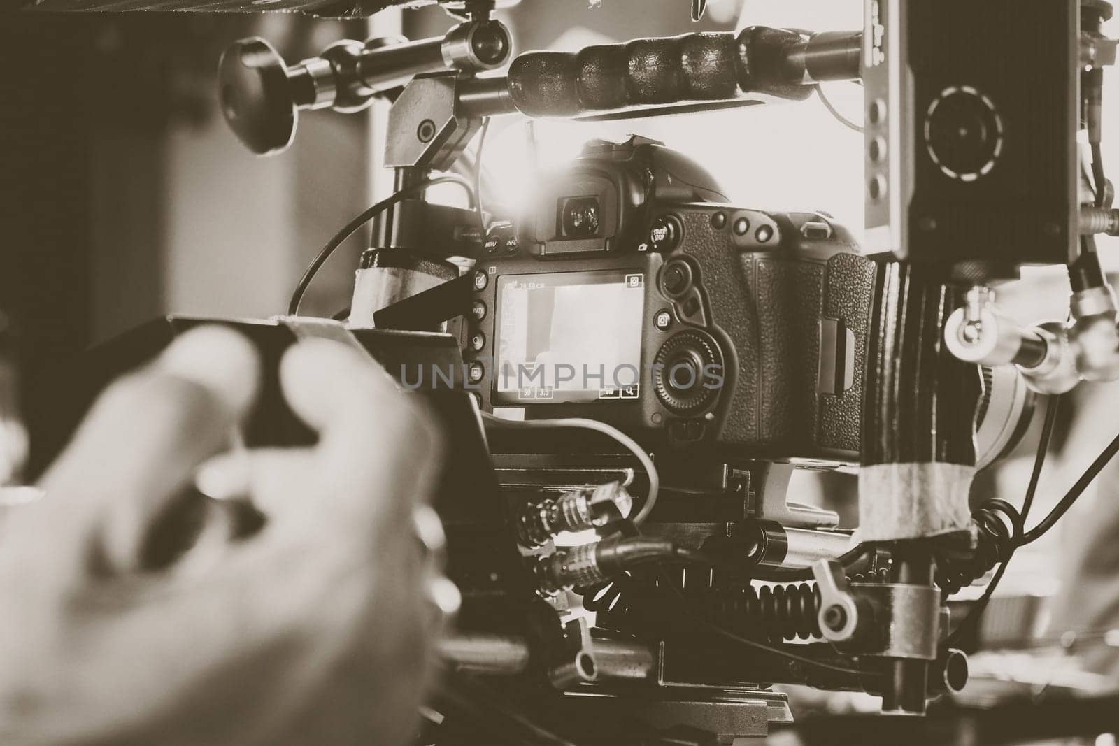 cinema video camera on tripod in film studio. by ponsulak