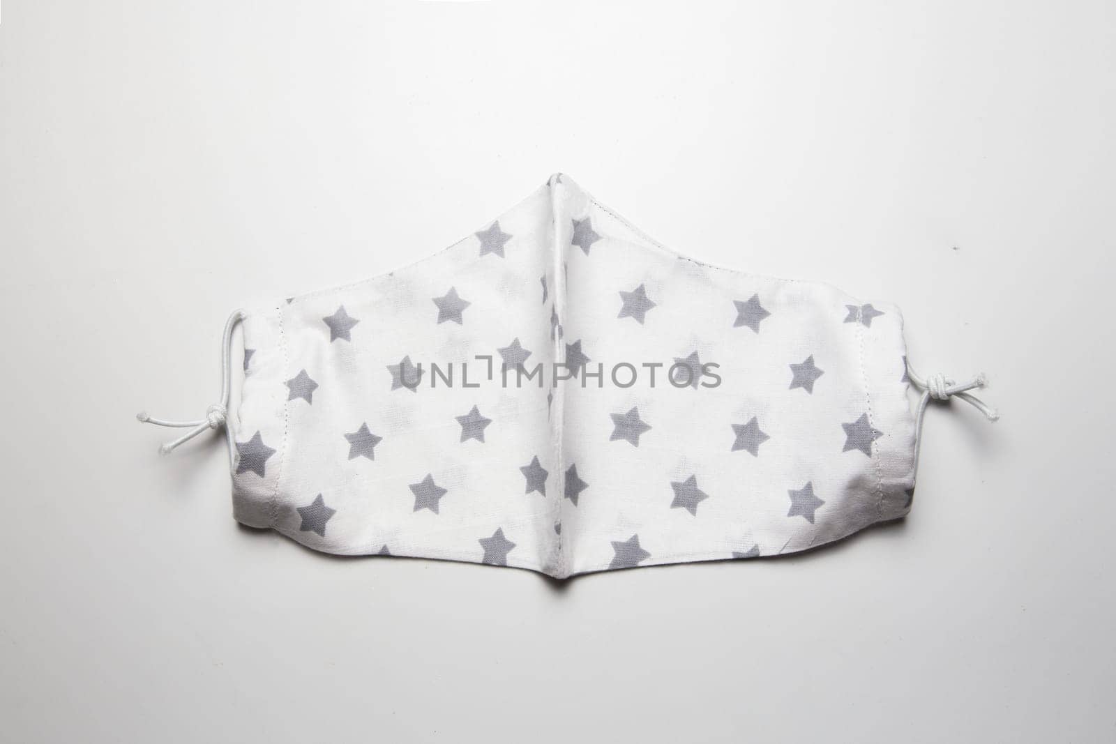 Fabric face mask isolated on a white background. by Dustick