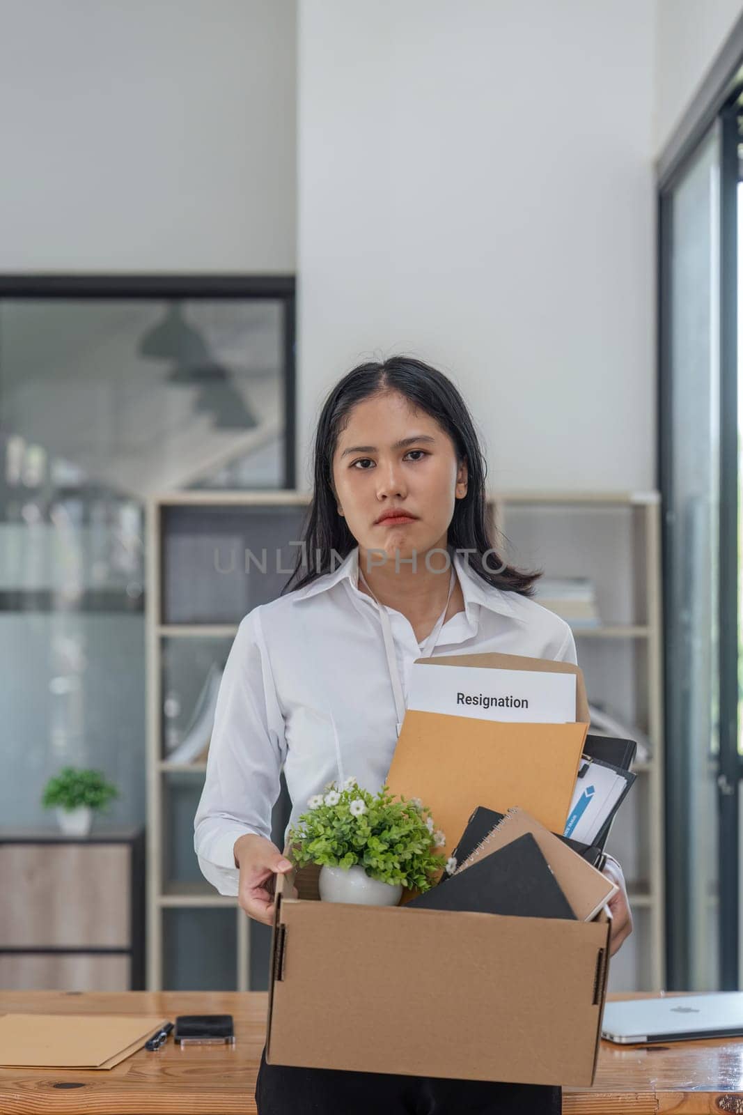 Sad and frustrated Asian female office worker her belonging, quitting a job. unemployment, resign, career failure.