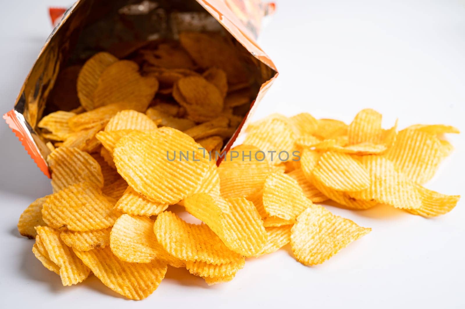 Potato chips, delicious BBQ seasoning spicy for crips, thin slice deep fried snack fast food in open bag.