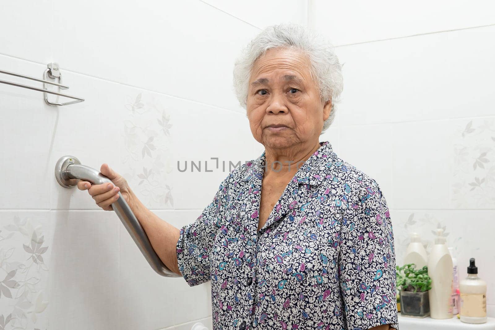 Asian elderly woman use toilet bathroom handle security, healthy strong medical concept.