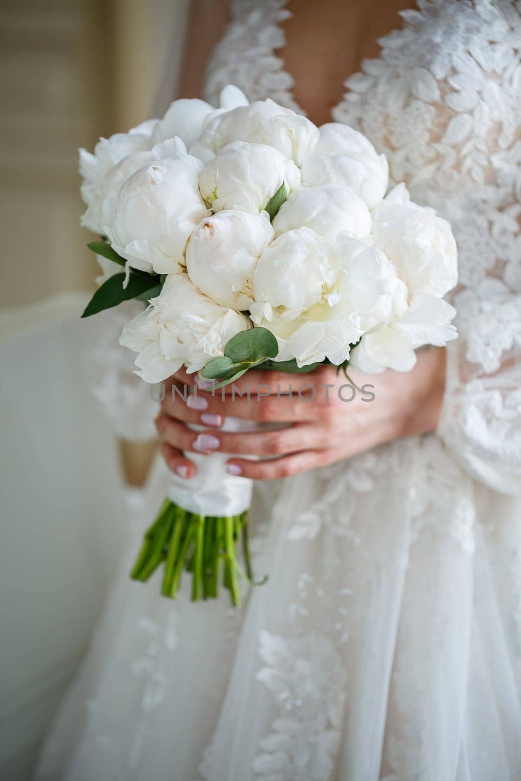 Hands of the bride close-up with a bouquet of fresh beautiful flowers. Attribute of the bride by Dmitrytph