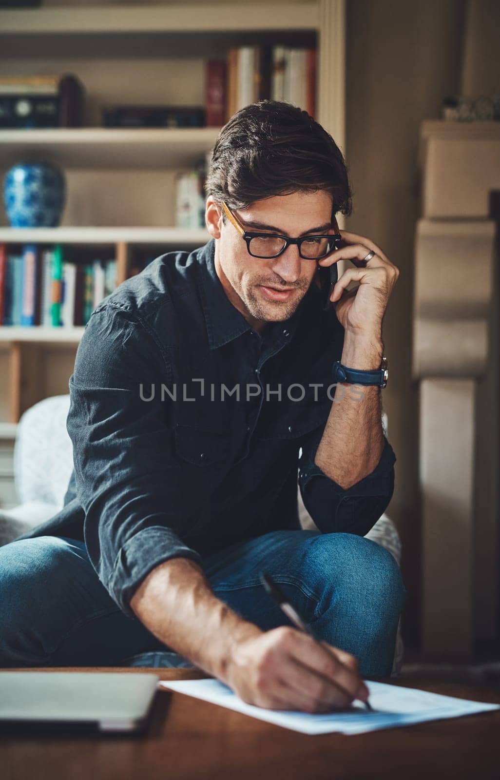 Home, phone call and man planning, business and conversation for new project, feedback and remote work. Male person, entrepreneur and consultant on a couch, smartphone and communication with ideas by YuriArcurs