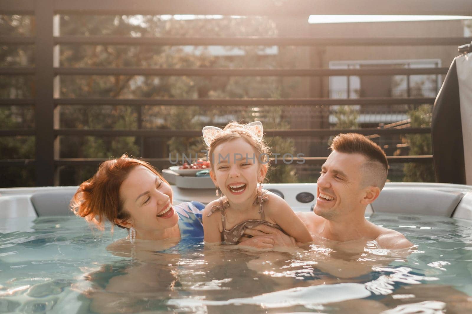 In summer, the family rests in the outdoor hot tub by Lobachad