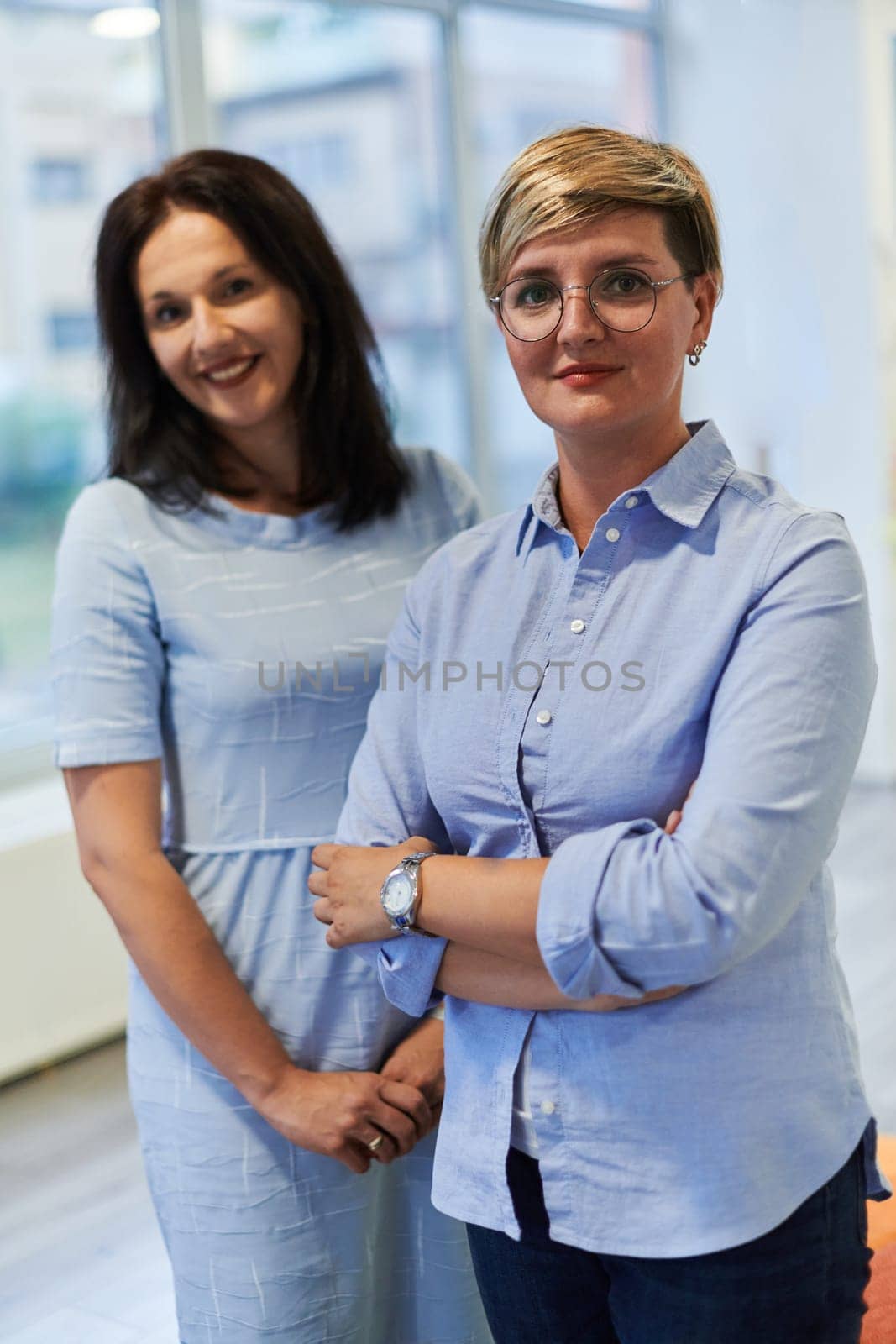 Portrait of a two teacher in a preschool institution, in the background of the classrooms by dotshock