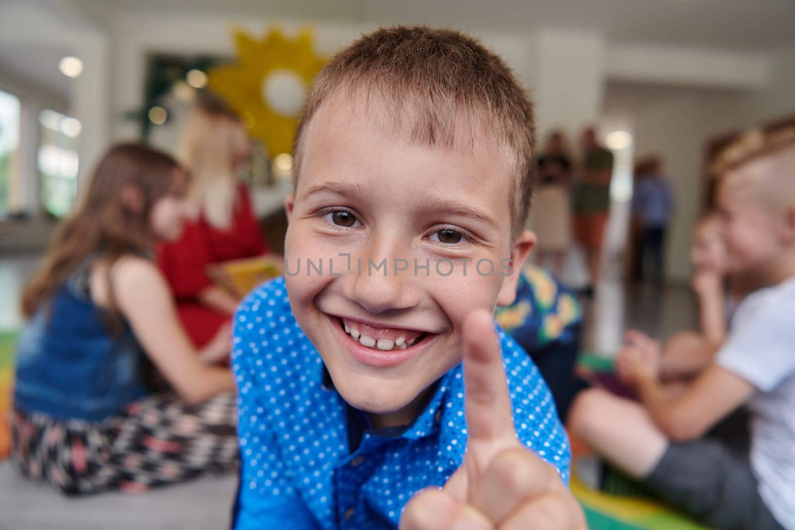 Portrait photo of a smiling boy in a preschool institution having fun. High quality photo