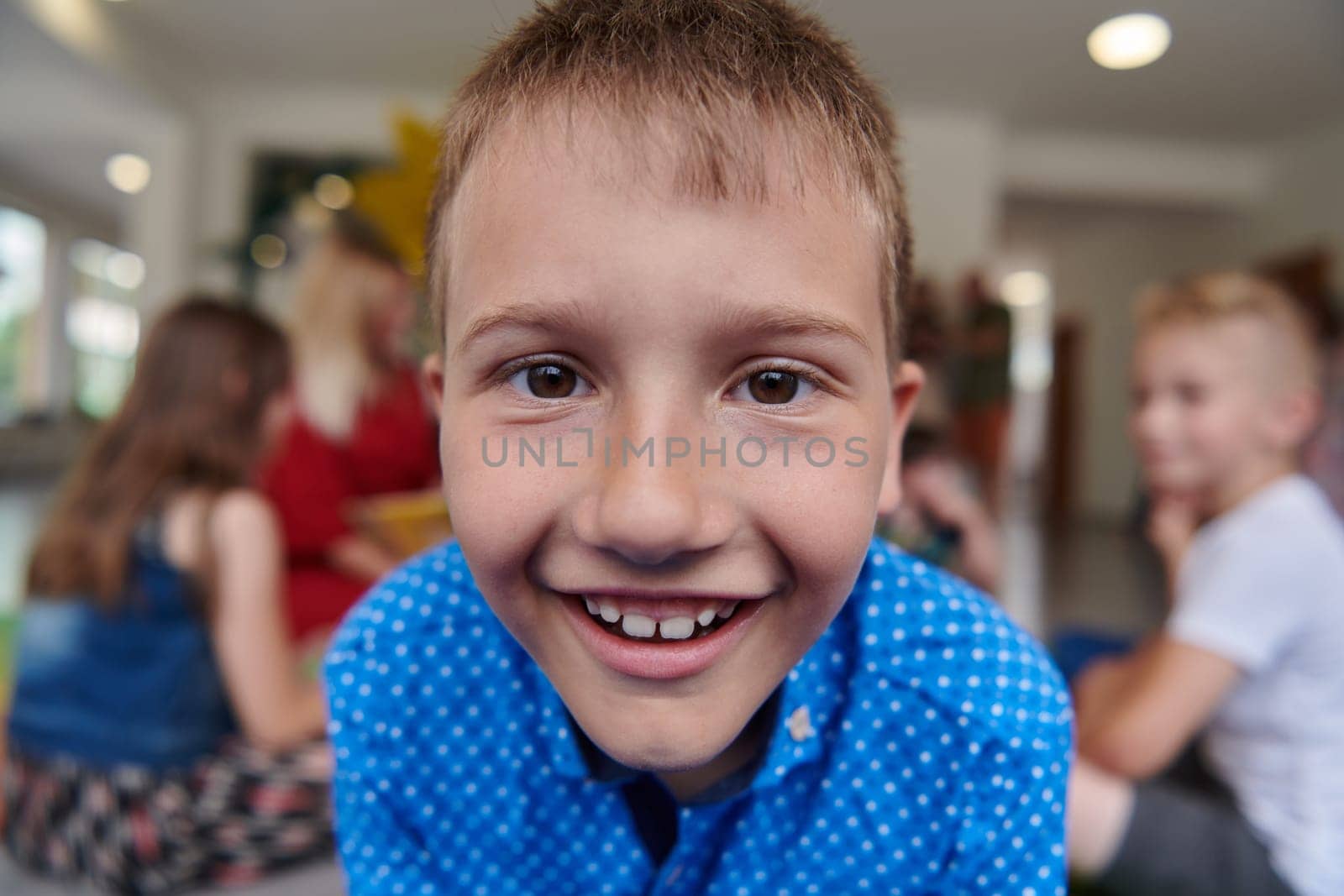 Portrait photo of a smiling boy in a preschool institution having fun. High quality photo