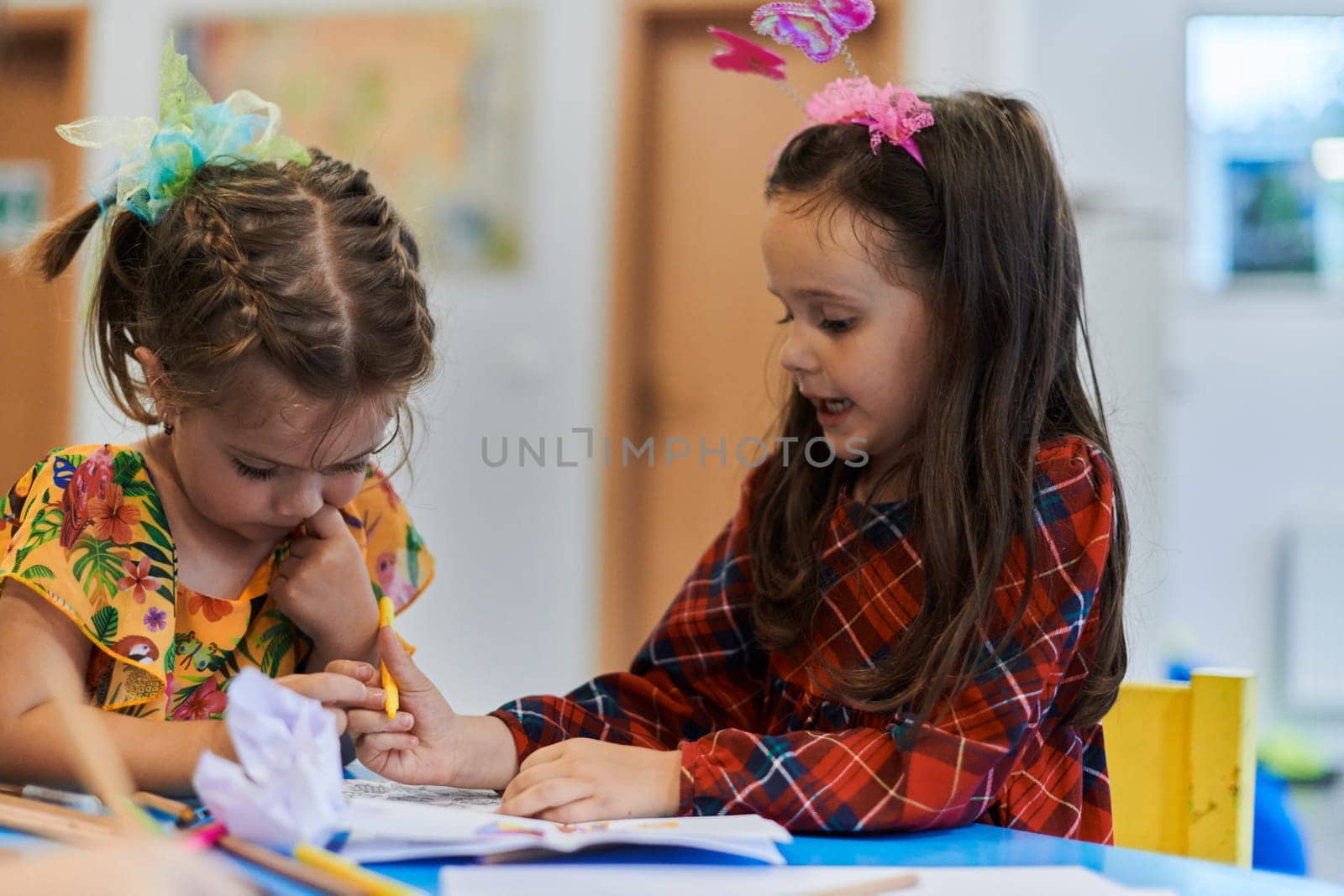 Creative kids sitting in a preschool institution, draw and have fun while they get an education. High quality photo