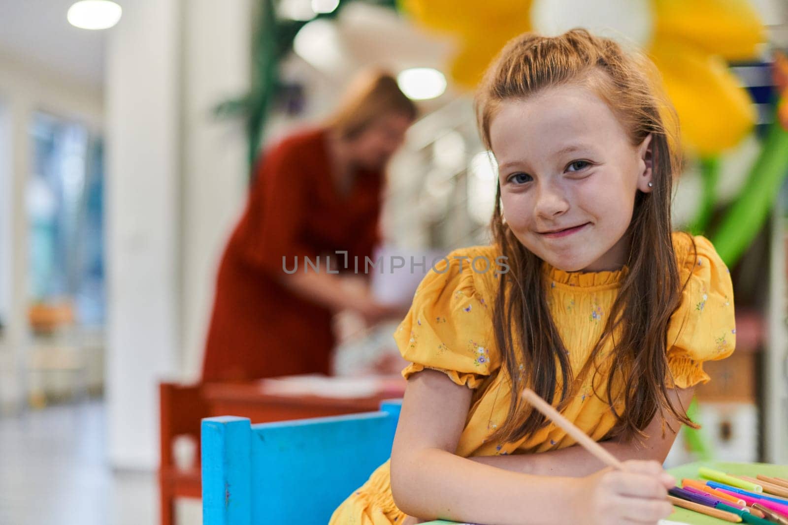 Creative kids sitting in a preschool institution, draw and have fun while they get an education. High quality photo