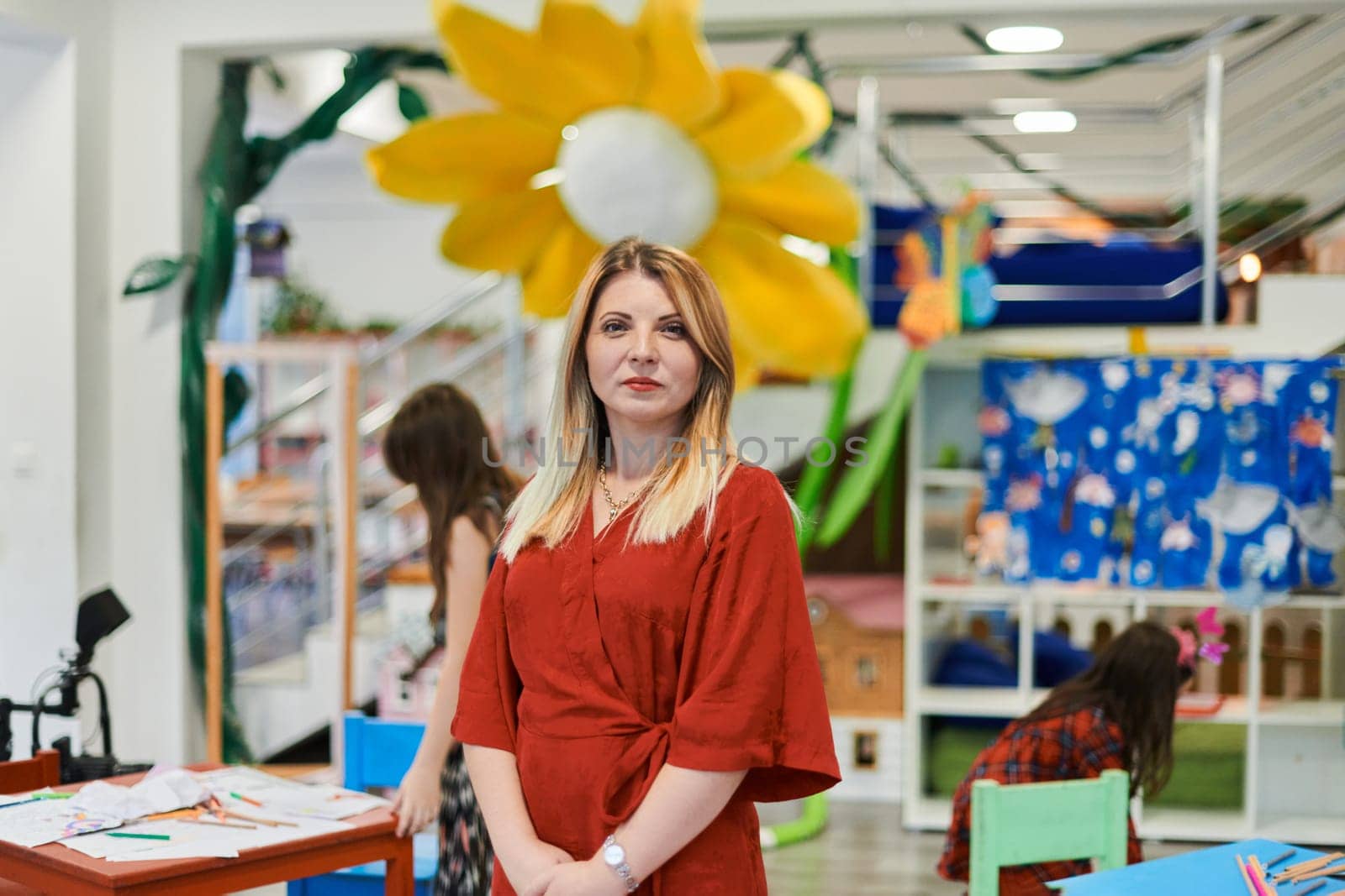 Portrait of a teacher in a preschool institution, in the background of the classrooms. High quality photo