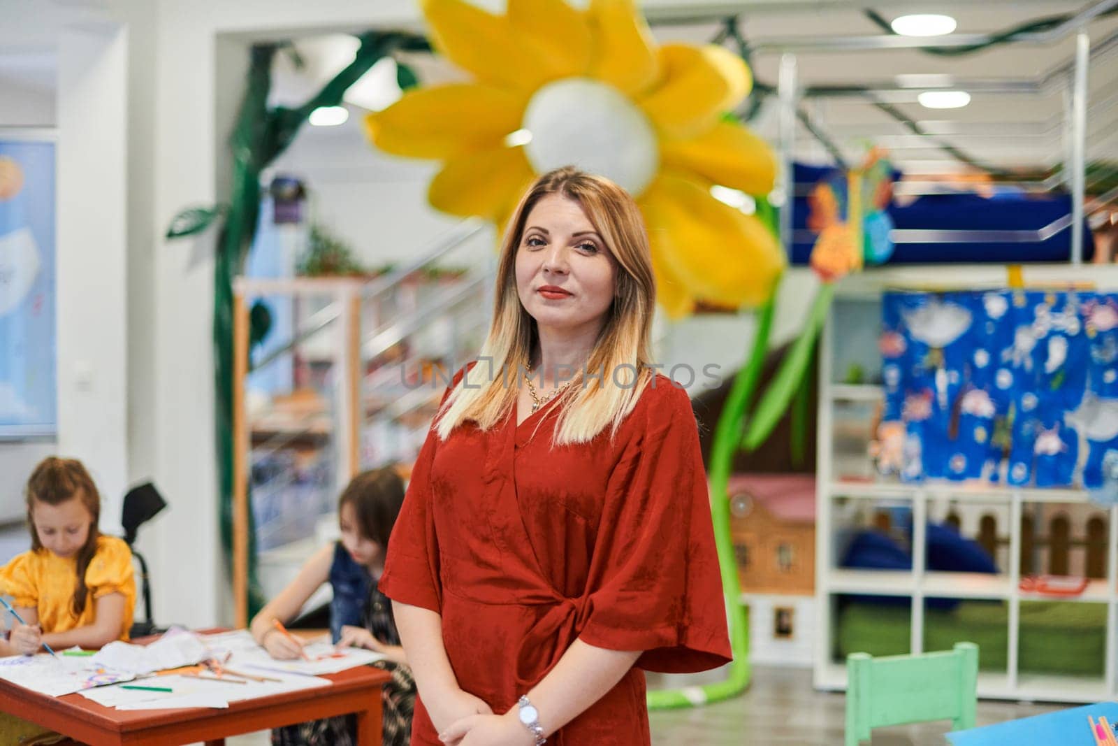 Portrait of a teacher in a preschool institution, in the background of the classrooms. High quality photo