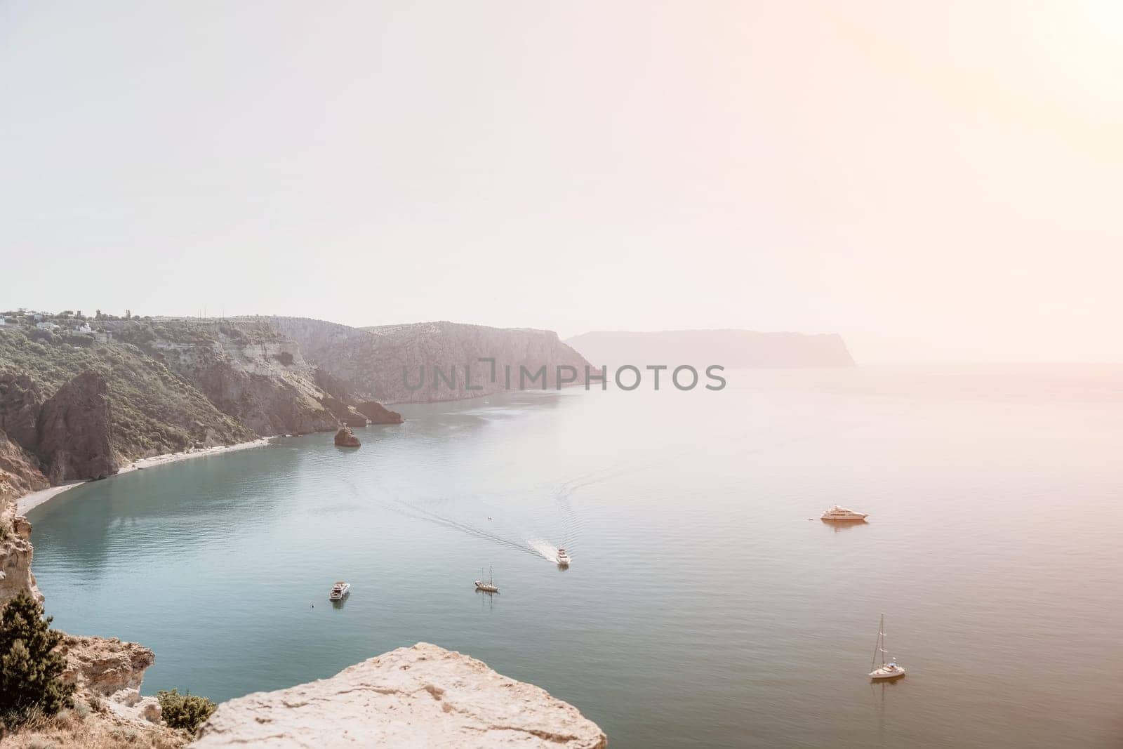 Aerial panoramic view of beautiful sunset above sea. Beautiful seascape. Sun glare, small waves on the water surface. Evening. Horizon. Nobody. No people. Copy space. Never-ending beauty of nature