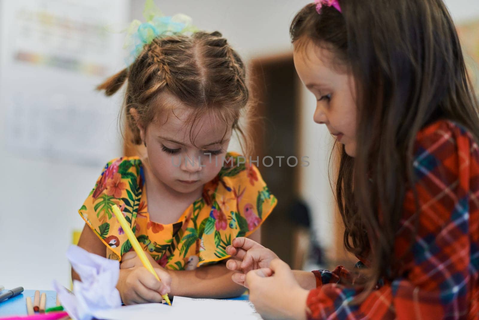 Creative kids sitting in a preschool institution, draw and have fun while they get an education. High quality photo