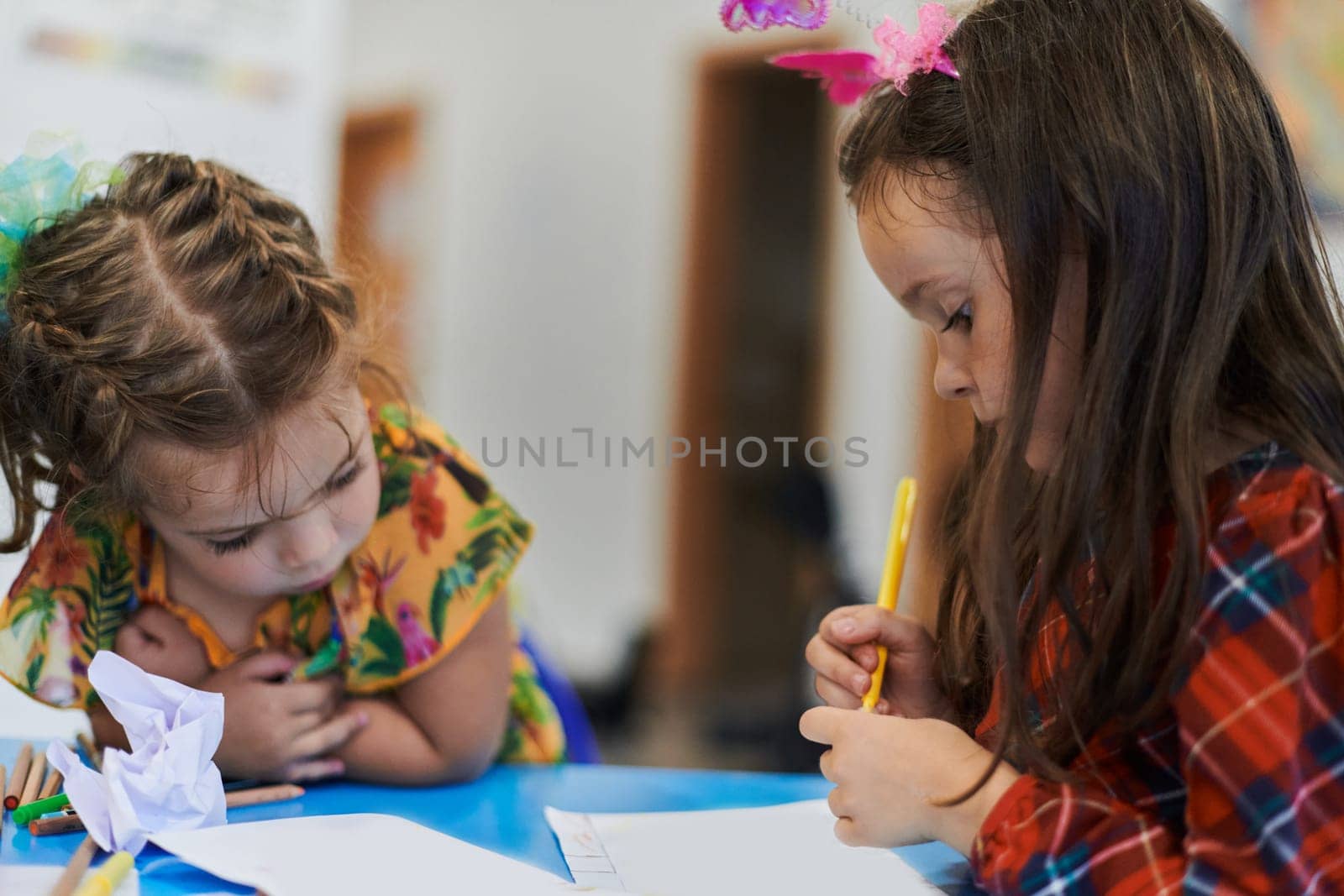 Creative kids sitting in a preschool institution, draw and have fun while they get an education by dotshock
