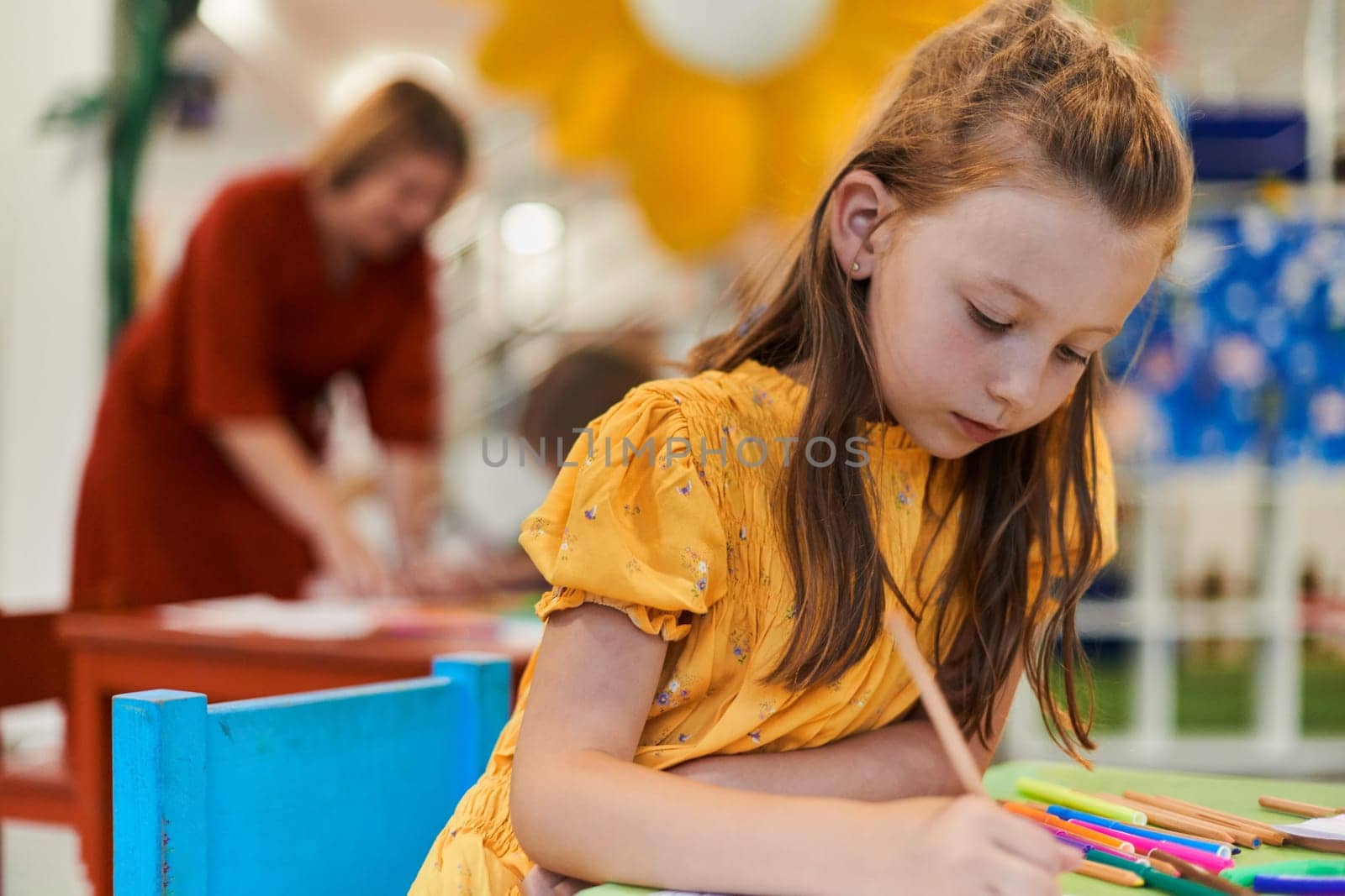 Creative kids sitting in a preschool institution, draw and have fun while they get an education. High quality photo