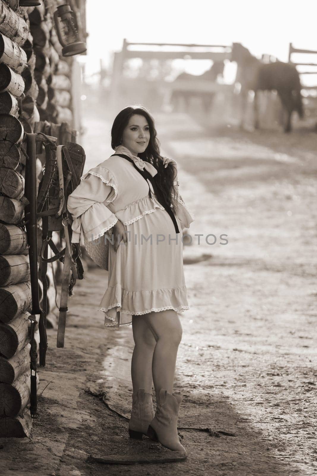 pregnant woman in a dress in the countryside.