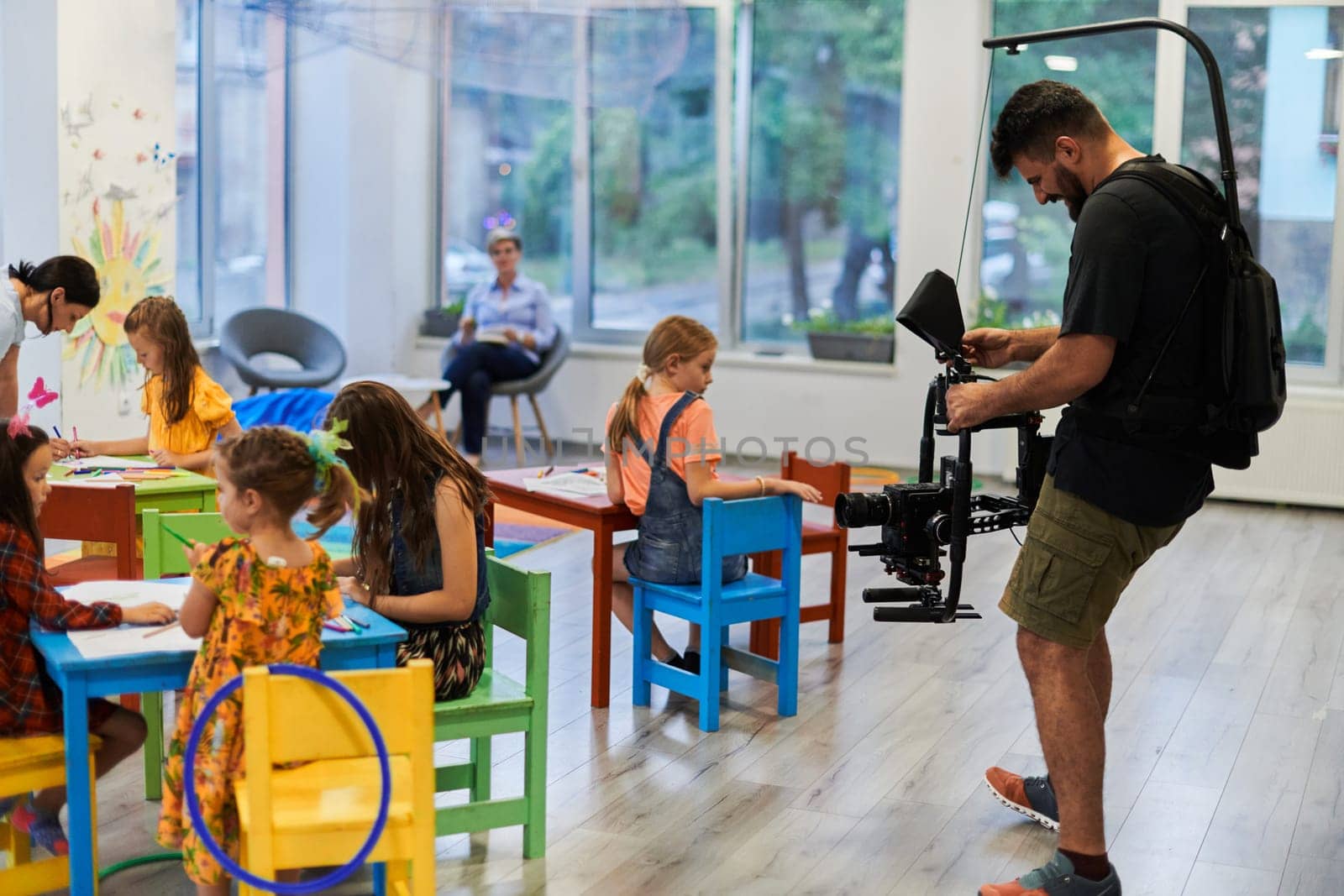 Cameraman films the joyful play and creative exploration of children at a preschool. High quality photo