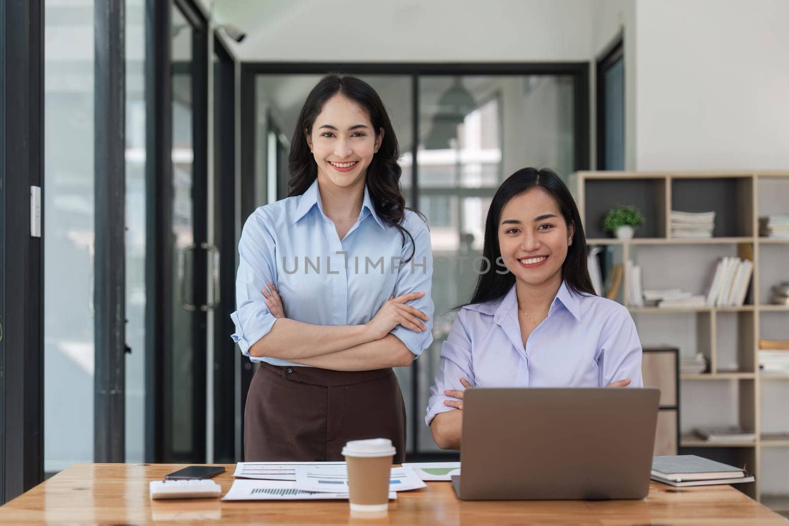 Two business workers smiling happy at the office.