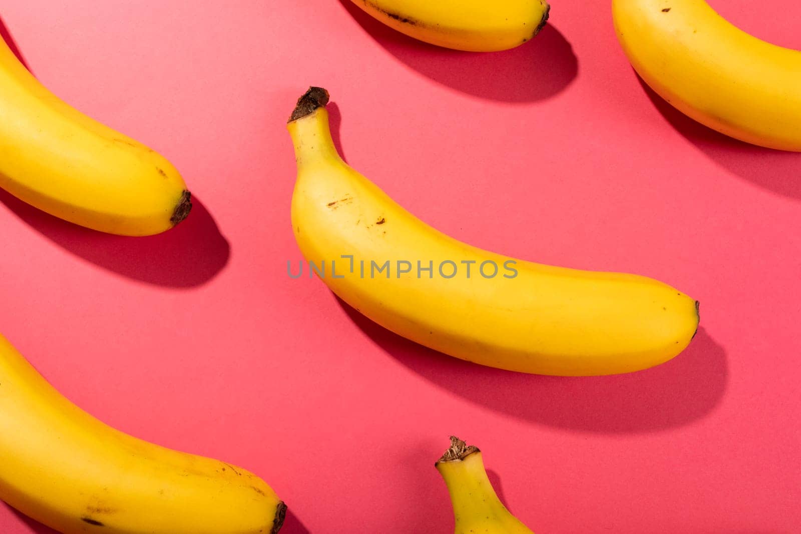 Overhead view of fresh bananas on pink background by Wavebreakmedia