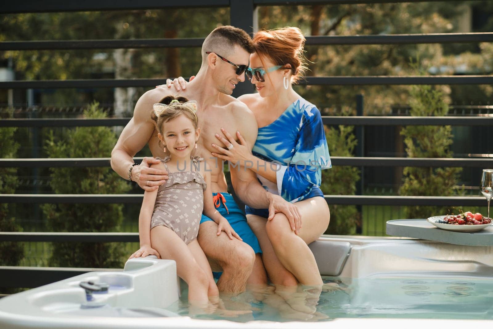 In summer, the family rests in the outdoor hot tub by Lobachad