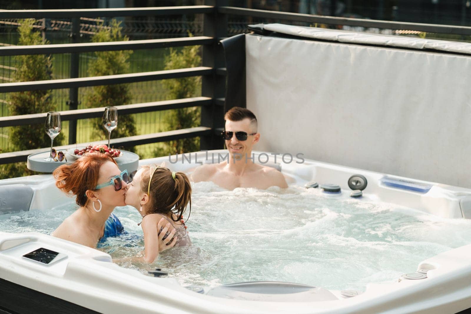 In summer, the family rests in the outdoor hot tub.