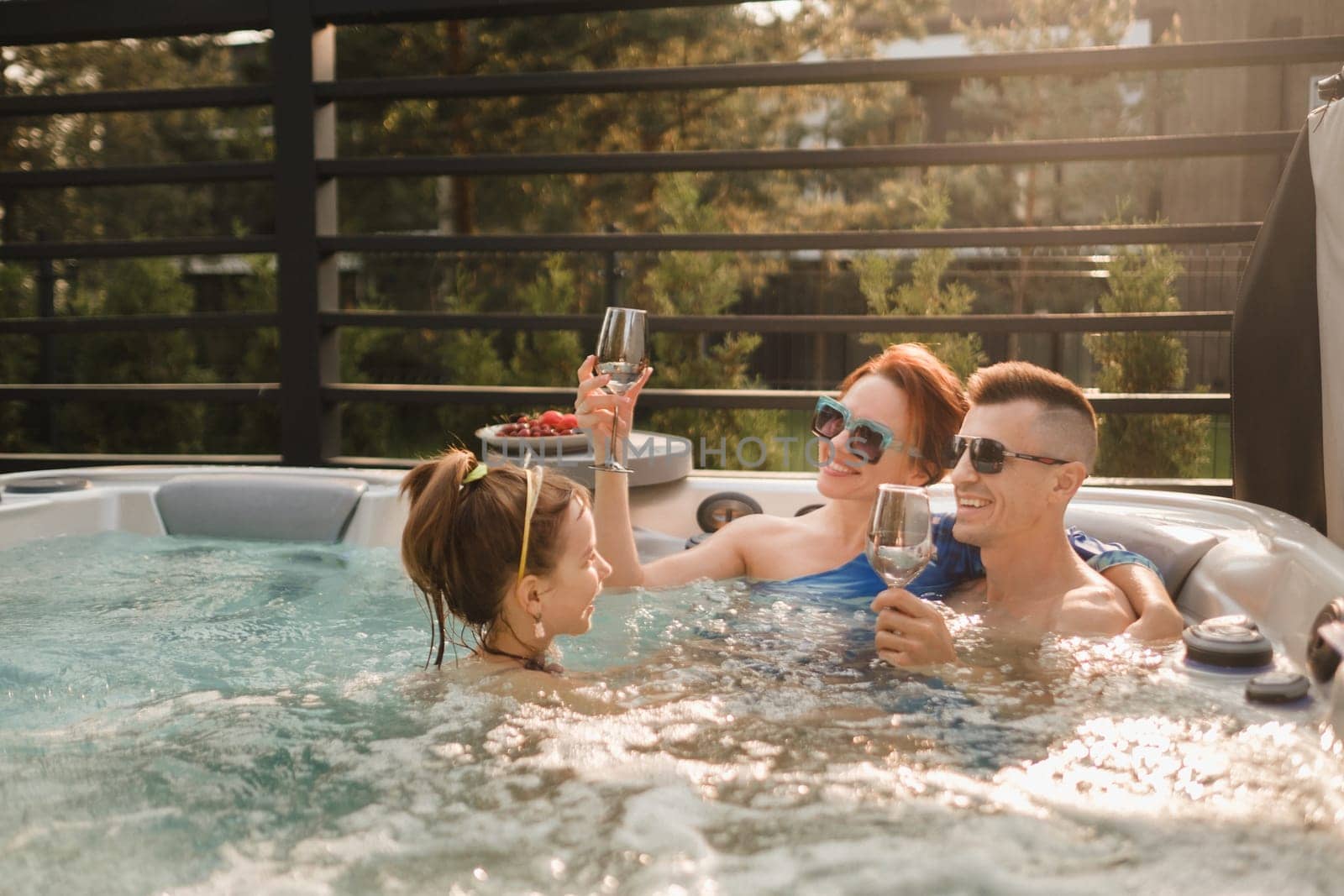 In summer, the family rests in the outdoor hot tub.