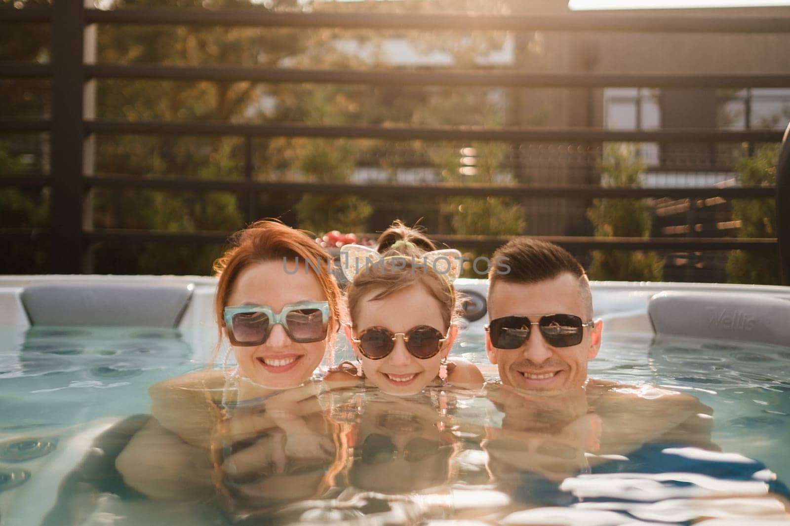 In summer, the family rests in the outdoor hot tub.