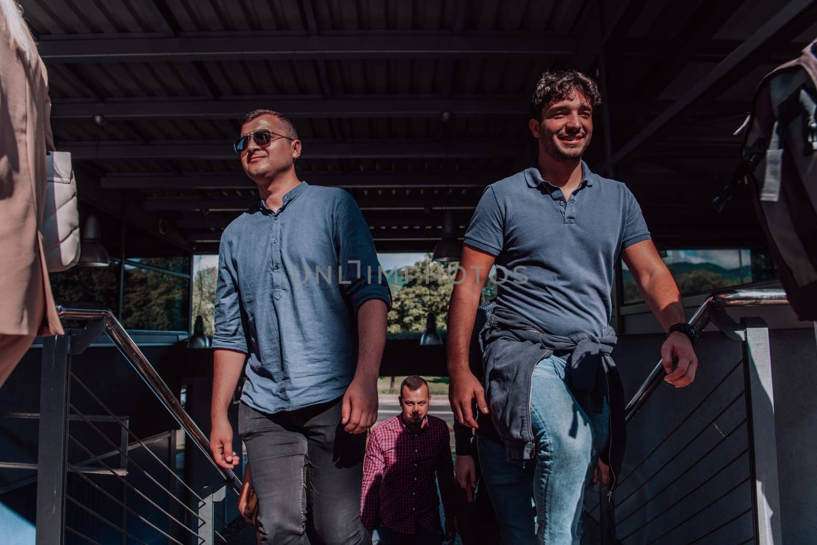 A diverse group of businessmen and colleagues walking together by their workplace, showcasing collaboration and teamwork in the company