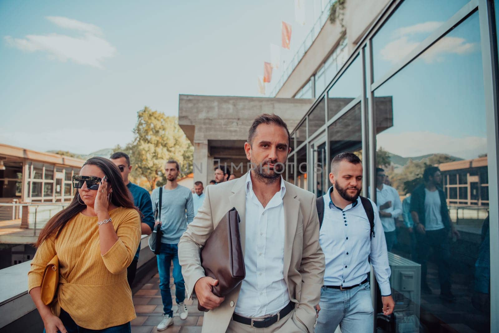 A diverse group of businessmen and colleagues walking together by their workplace, showcasing collaboration and teamwork in the company