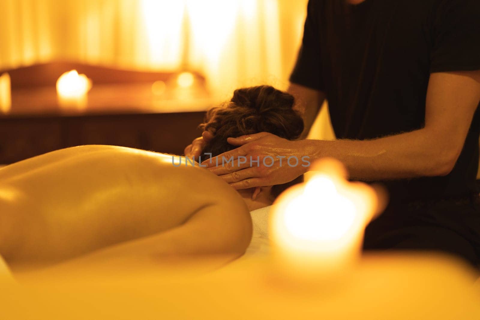 Massage session in SPA salon - massaging the head of a woman. Mid shot