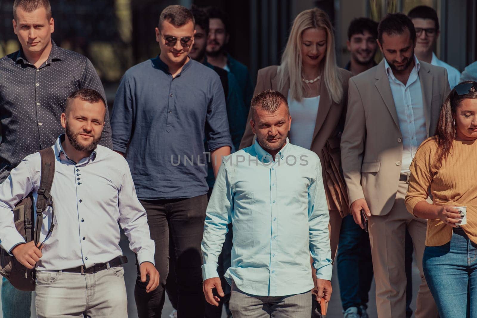 A diverse group of businessmen and colleagues walking together by their workplace, showcasing collaboration and teamwork in the company