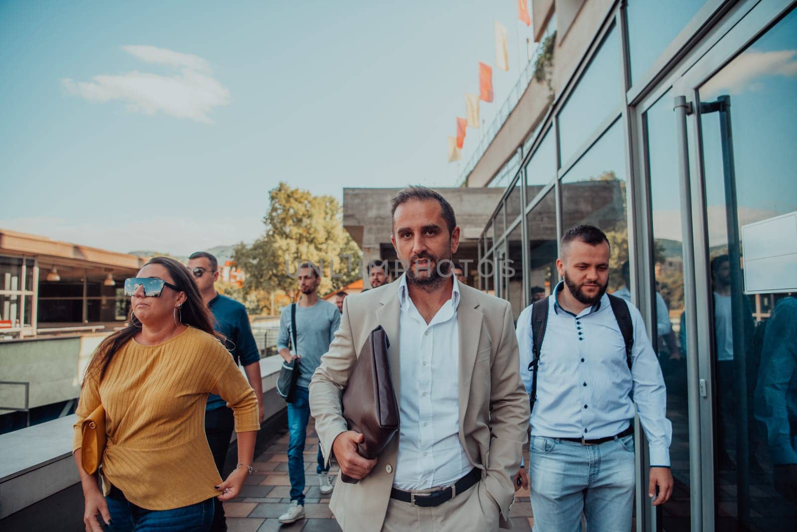 A diverse group of businessmen and colleagues walking together by their workplace, showcasing collaboration and teamwork in the company