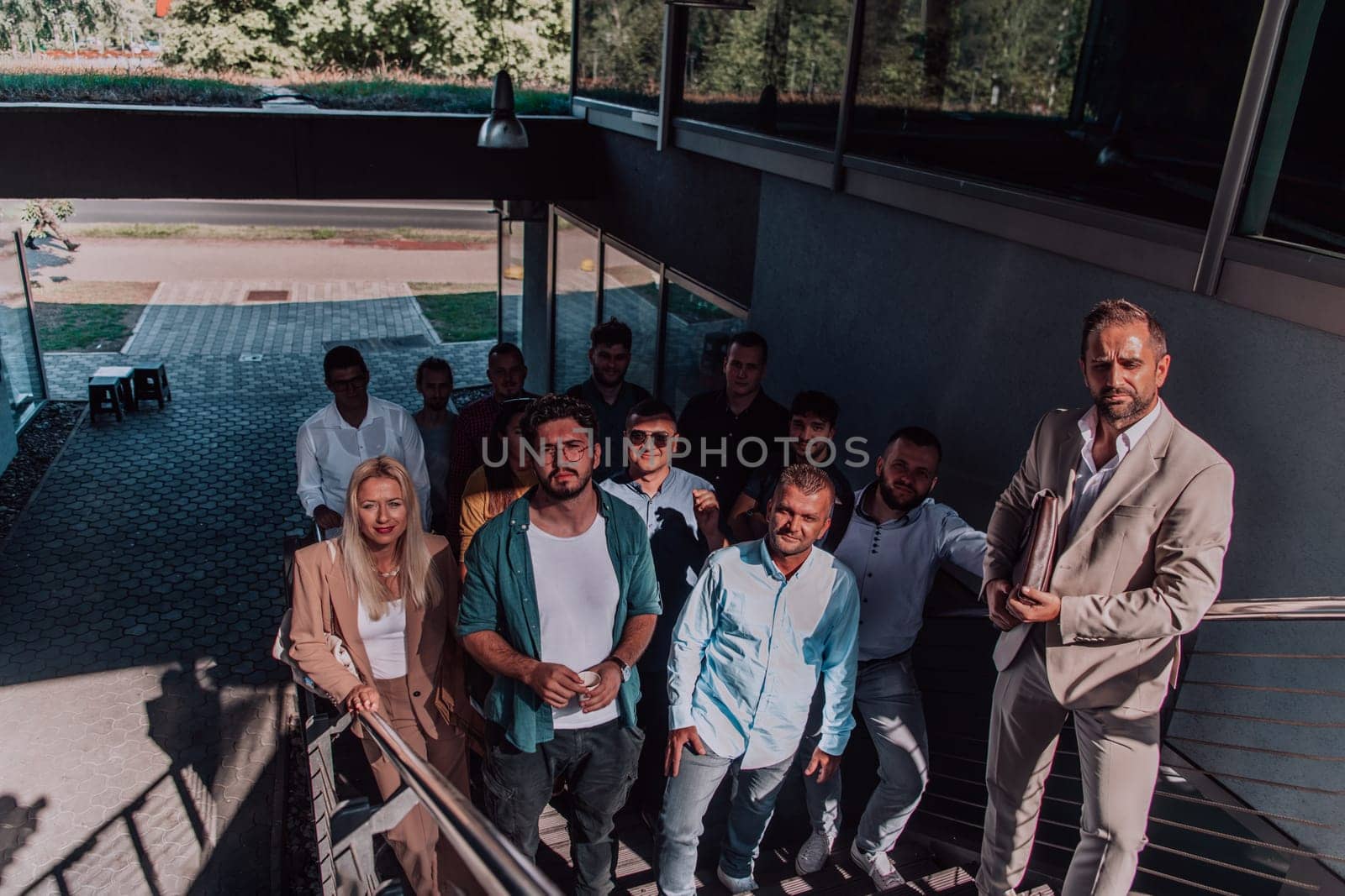 A diverse group of businessmen and colleagues walking together by their workplace, showcasing collaboration and teamwork in the company