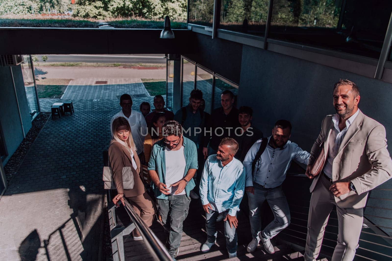 A diverse group of businessmen and colleagues walking together by their workplace, showcasing collaboration and teamwork in the company