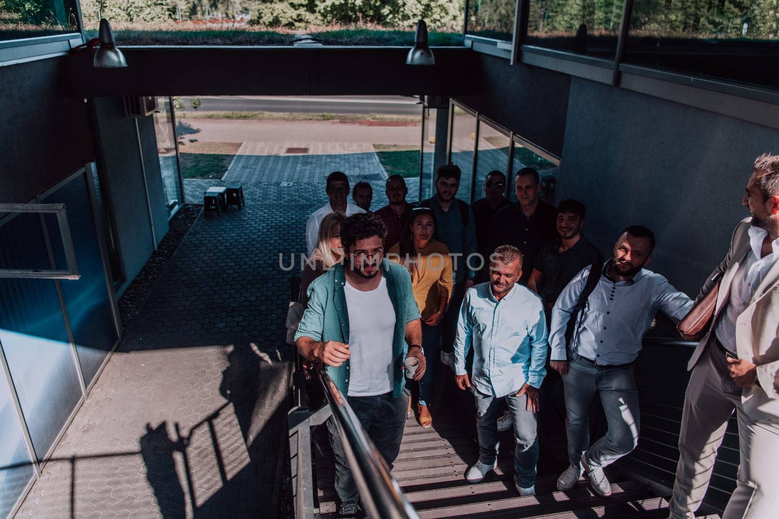 A diverse group of businessmen and colleagues walking together by their workplace, showcasing collaboration and teamwork in the company