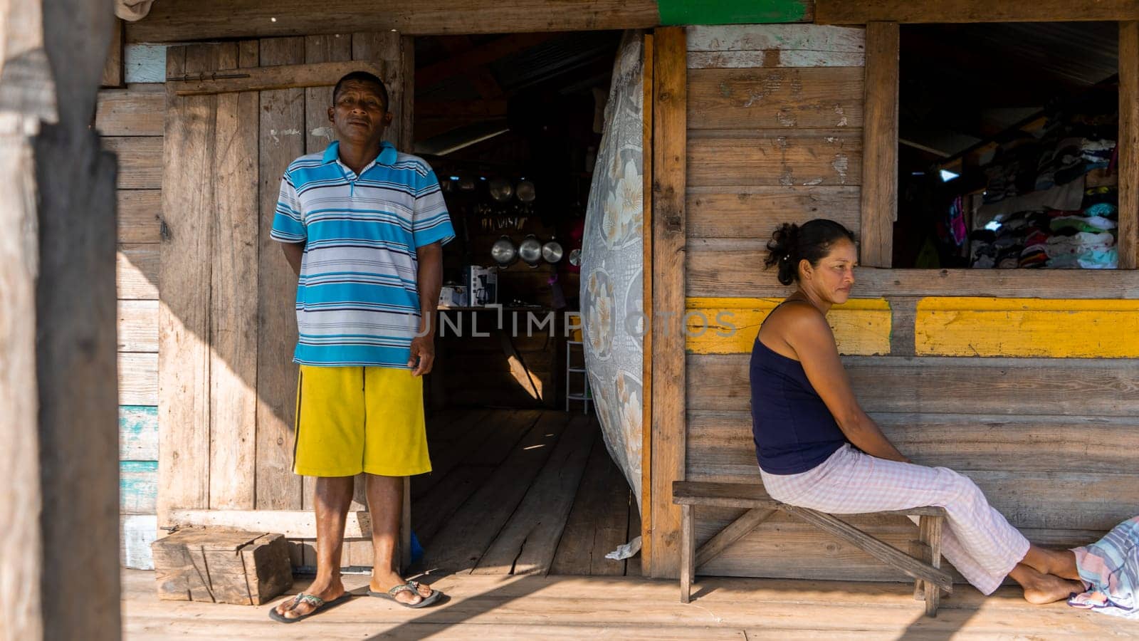 Indigenous man and woman outside their wooden house in the caribbean of Nicaragua