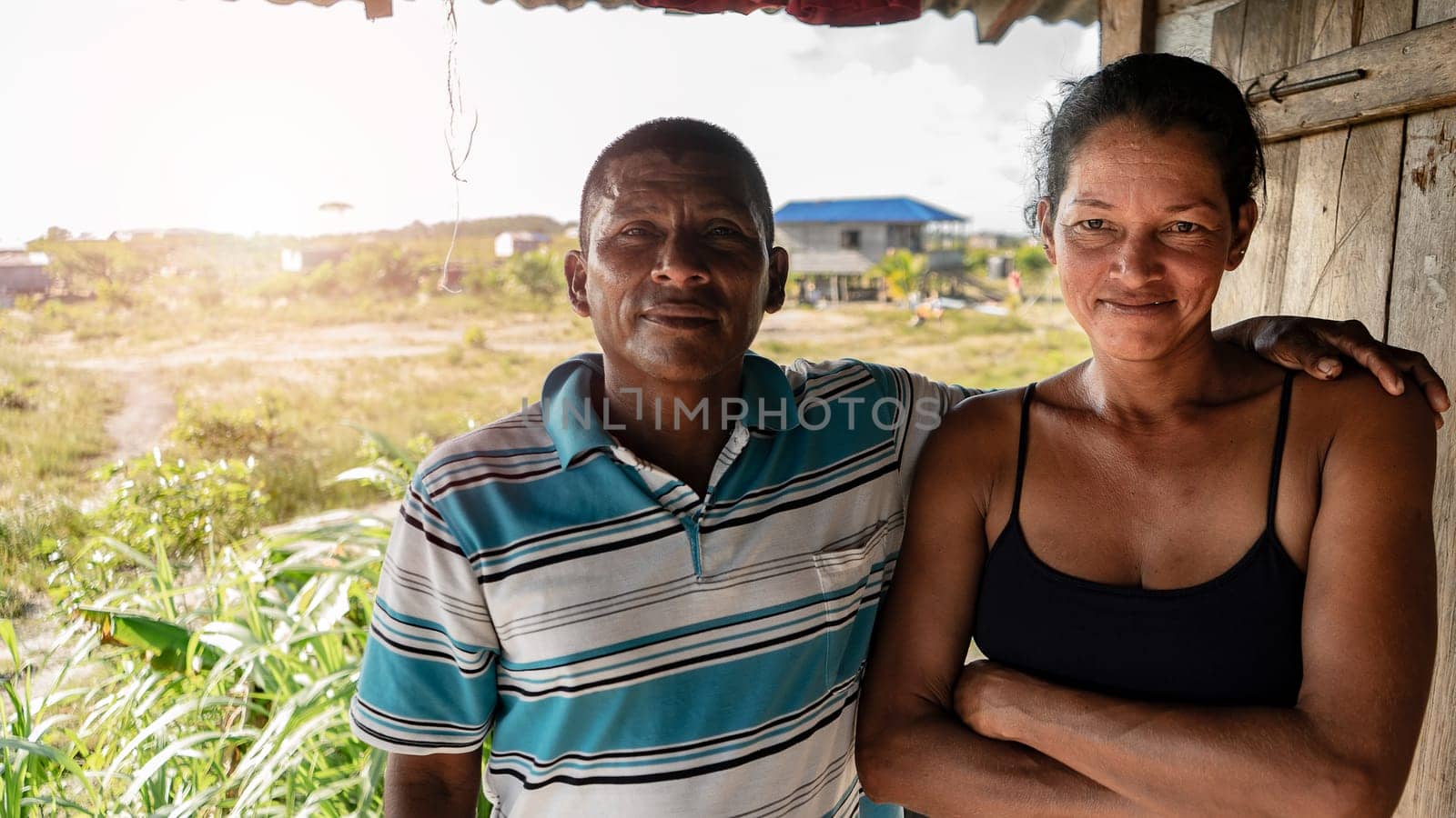 Indigenous man and woman from the Caribbean of Nicaragua and Central America hugging and looking at camera by cfalvarez