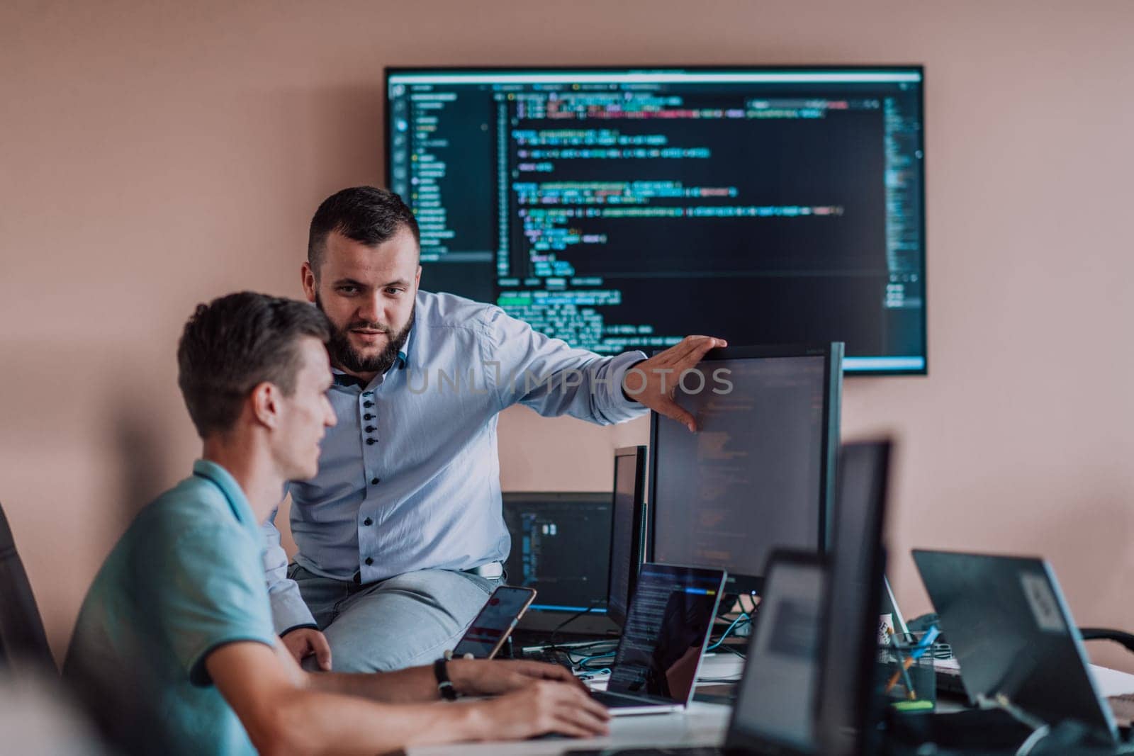 Programmers engrossed in deep collaboration, diligently working together to solve complex problems and develop innovative mobile applications with seamless functionality