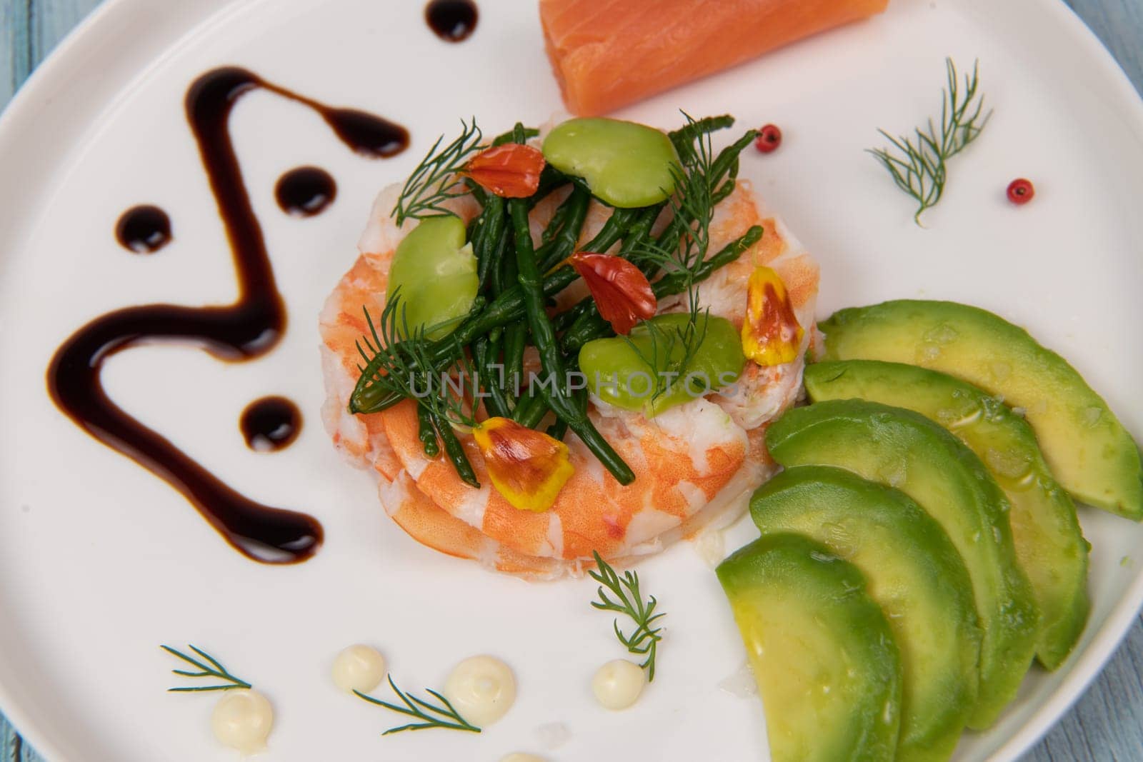 Recipe Fish Appetizer shrimp carpaccio, smoked salmon, avocado, samphire, broad beans, lemon sauce, olive oil, served with mayonnaise in white round plate, High quality photo