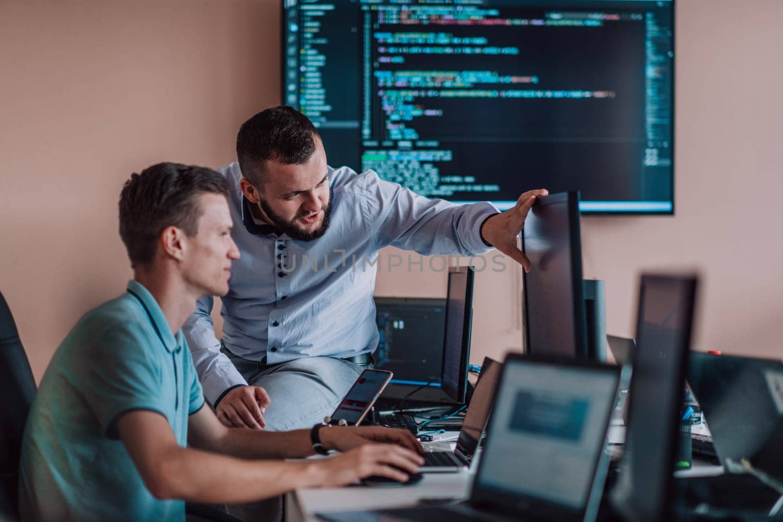 Programmers engrossed in deep collaboration, diligently working together to solve complex problems and develop innovative mobile applications with seamless functionality